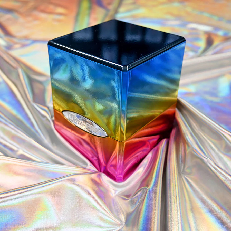 Ultra PRO: Satin Tower: Hi-Gloss Rainbow Deck Box with a rainbow gradient, glossy black top, and snap-fit locking, resting on holographic fabric.