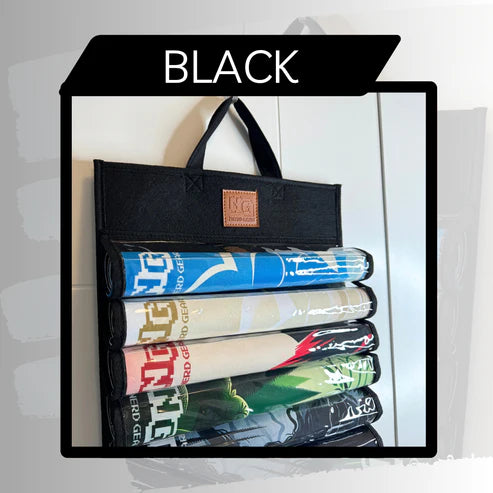 Nerd Gear Playmat Sanctuary: Black roll mat organizer with handle, leather logo patch, and five playmats inside, designed for playmat storage and easy access.