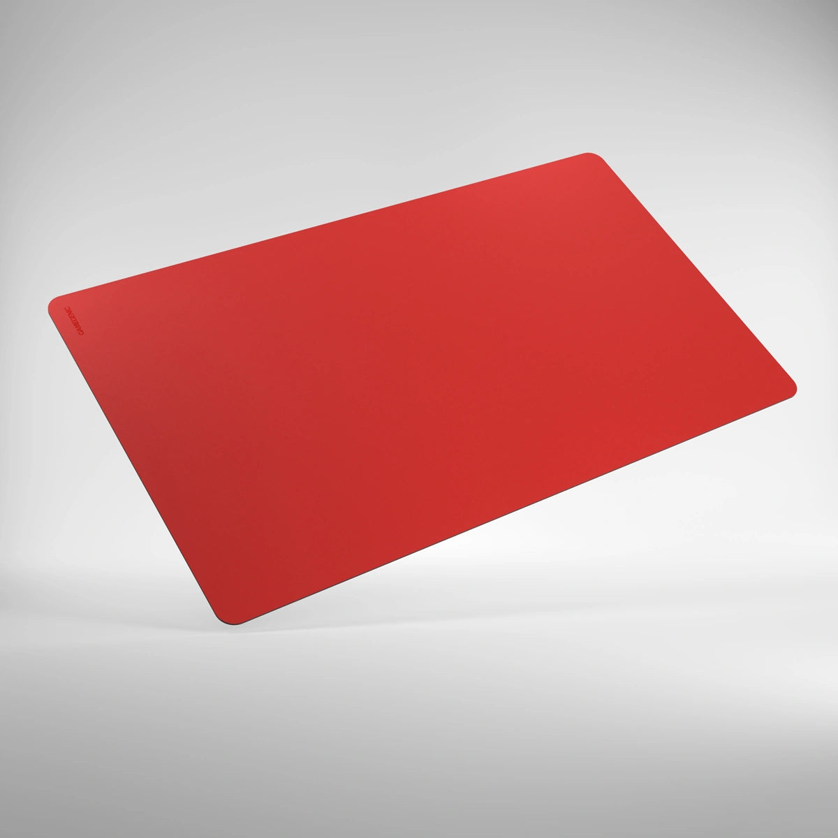 GameGenic: Playmat: Prime: Red, a large, slim rectangular desk-mat with rounded corners, floating above a white surface, showcasing its softly cushioned, anti-slip design.
