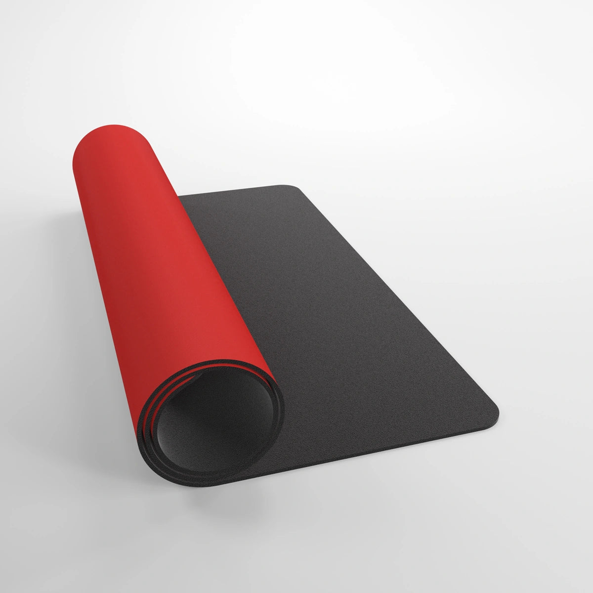 GameGenic: Playmat: Prime: Red, rolled up showing red top and black anti-slip underside, ideal for card games with a softly cushioned, ultra-fine surface.