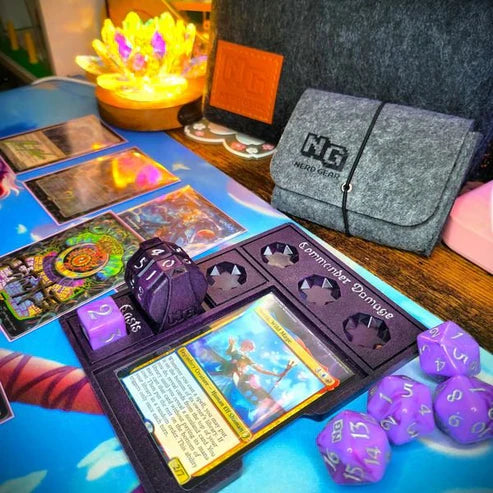 Nerd Gear Commander Essentials Kit setup with cards, dice, tracker board, and felt deck-box, ideal for MTG Commander games at Moonveil Games.